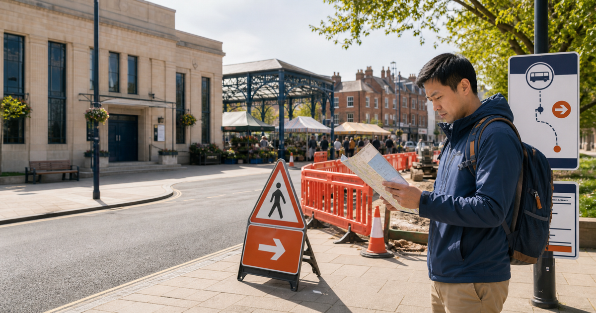 A visitor checks a town map beside temporary roadworks and a changed bus route