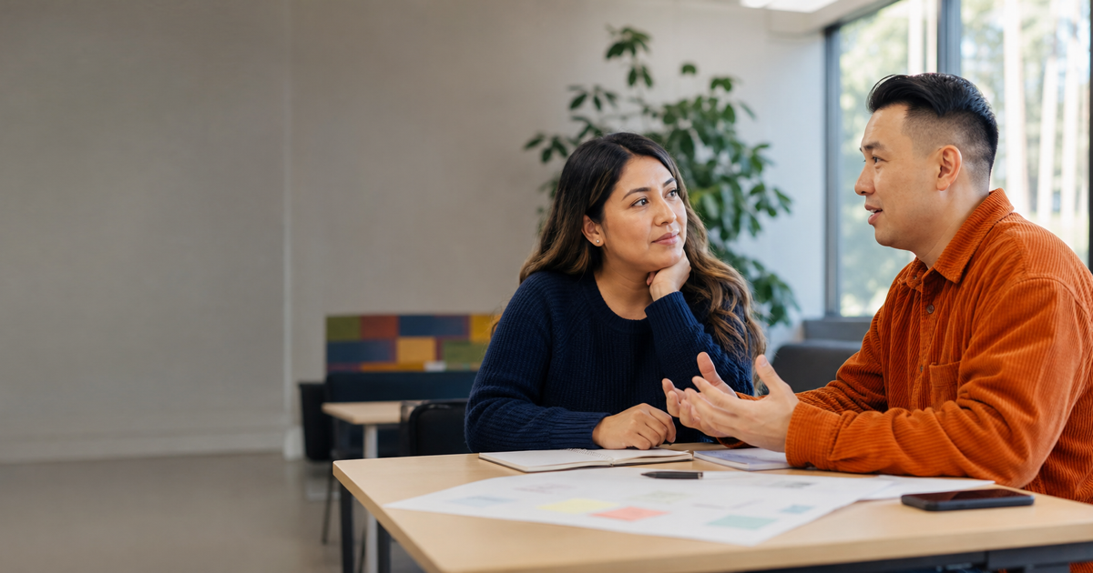 Two adult learners discuss their strengths and suitable roles for a shared project