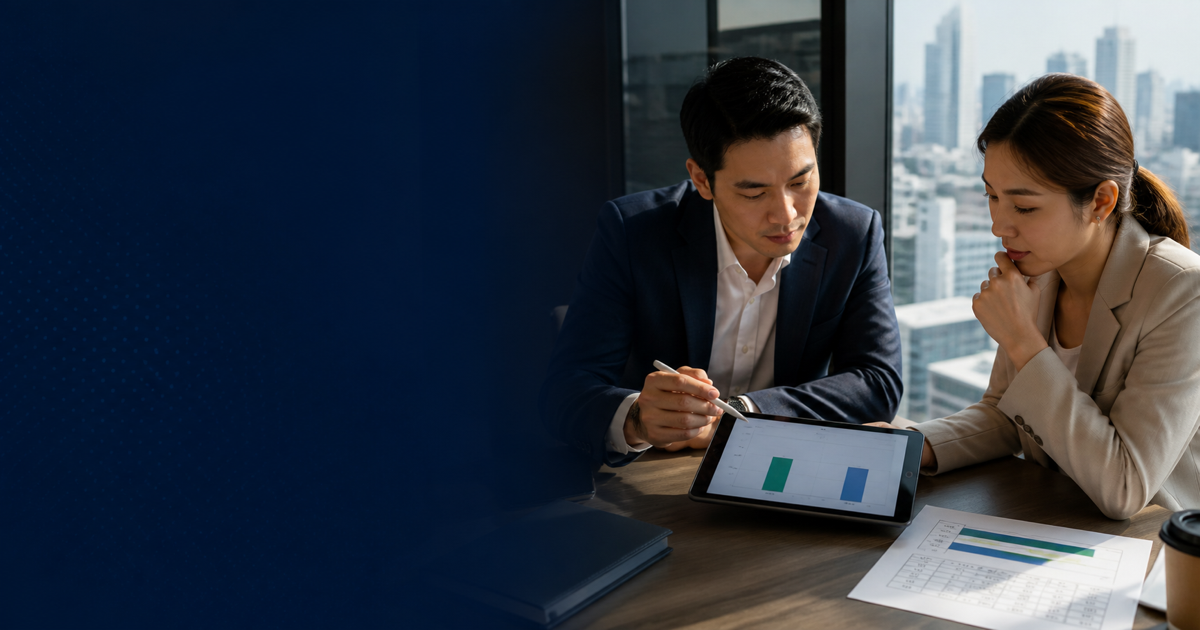 Two Thai professionals compare option data on a tablet before making a recommendation