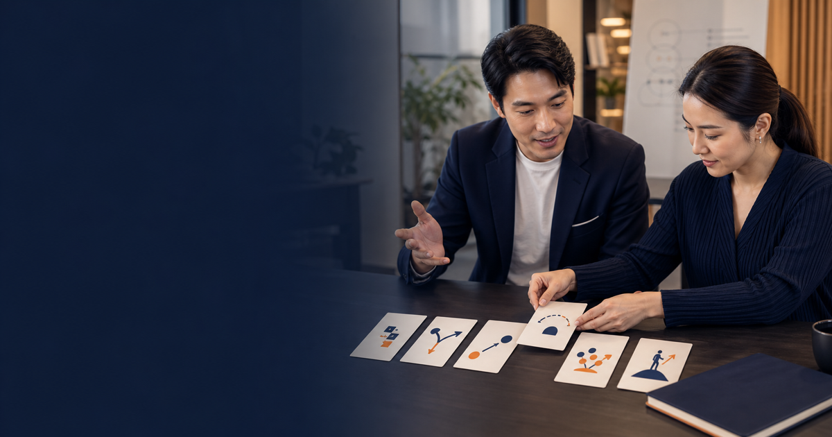 Two Thai professionals organise discourse-function cards for a nuanced explanation