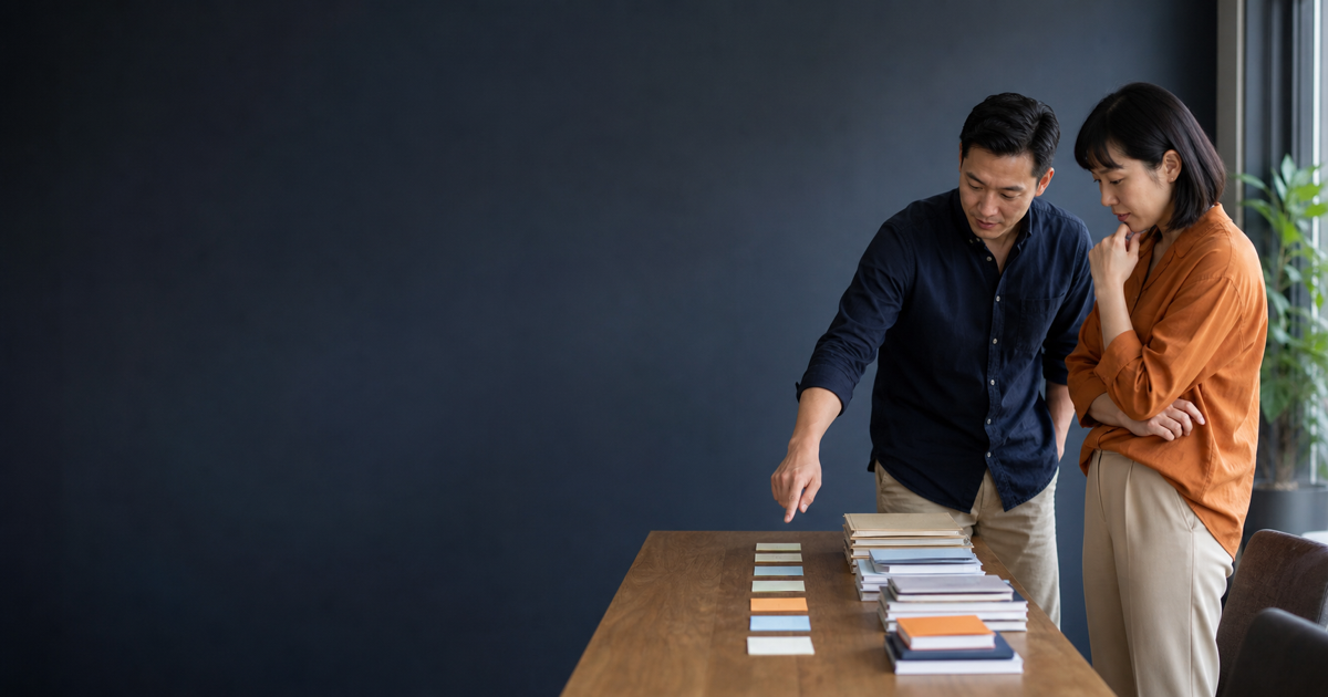 Two colleagues review the progress of a long-running project using a physical timeline